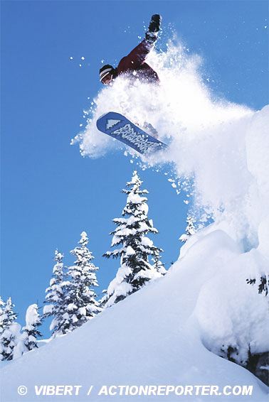 Snowboard action jump in fresh powder