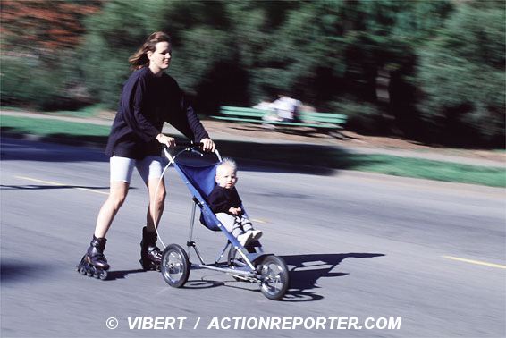 Womanin line skating with her baby